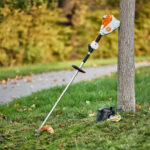 STIHL FSA 120 R battery grass trimmer against tree